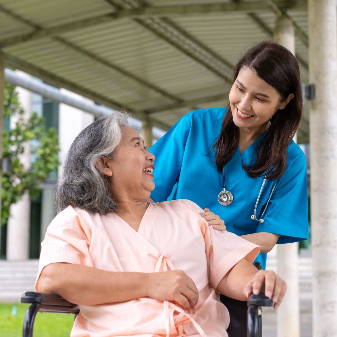 Caregiver and senior woman smiling at each other