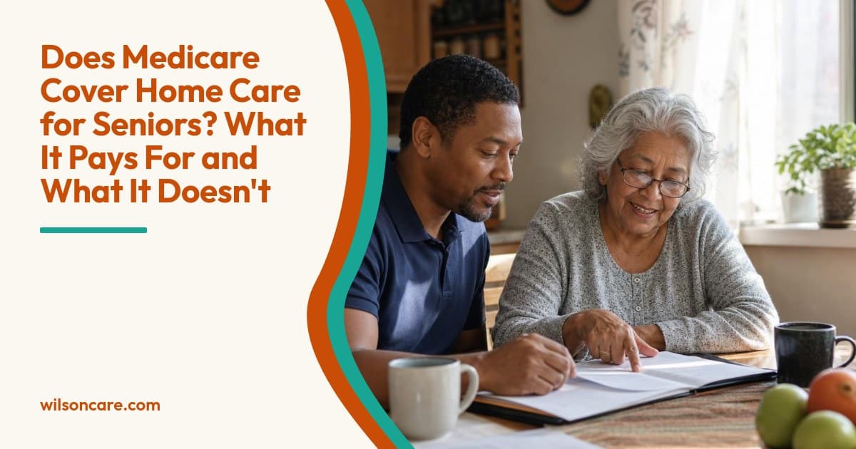 A caregiver and an older woman look over paperwork together at her sunlit kitchen table, smiling and relaxed.